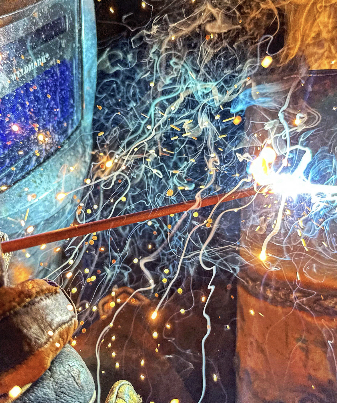 person welding with mask on