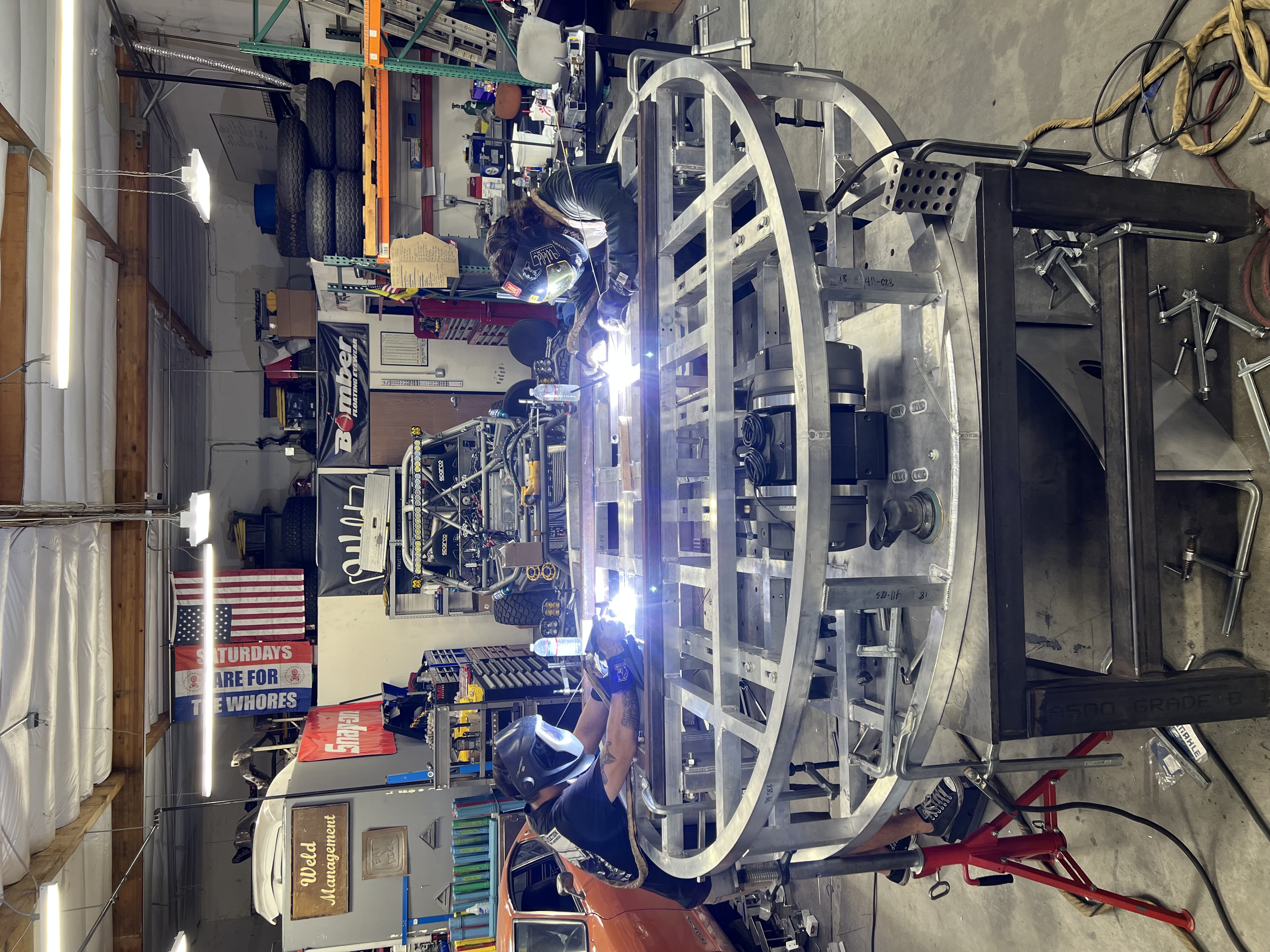 two people welding metal